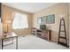 Bright bedroom with neutral decor, large window, TV on console, and floor lamp at 11230 Osage Cir # B, Northglenn, CO 80234