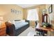 Cozy bedroom featuring a daybed, desk, and a window with natural light at 11230 Osage Cir # B, Northglenn, CO 80234