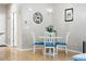 Cozy dining area features a white table and chairs, with a view into the living room at 11230 Osage Cir # B, Northglenn, CO 80234