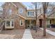 Well-maintained townhome featuring stone accents, a covered entrance, and manicured landscaping at 11230 Osage Cir # B, Northglenn, CO 80234
