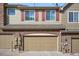 Two-story townhouse featuring a brick base, siding, and a two-car garage at 11230 Osage Cir # B, Northglenn, CO 80234