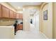 Neutral hallway with built-in desk area and wood cabinets providing ample storage and workspace at 11230 Osage Cir # B, Northglenn, CO 80234