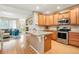 Modern kitchen featuring stainless steel appliances, granite countertops, and wood cabinets at 11230 Osage Cir # B, Northglenn, CO 80234