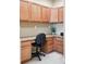 Close up view of a home office nook with wood cabinets, desk, and a comfortable office chair at 11230 Osage Cir # B, Northglenn, CO 80234