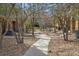 Landscaped path leads through well-maintained grounds with mature trees and flowering bushes at 11230 Osage Cir # B, Northglenn, CO 80234