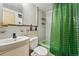 Updated bathroom with modern fixtures, tiled walls, and a green-themed shower at 1175 N Emerson St # 103, Denver, CO 80218