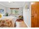 Bright bedroom featuring hardwood floors, a ceiling fan, and ample natural light at 1175 N Emerson St # 103, Denver, CO 80218