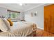 Cozy bedroom with hardwood floors and a large window offering natural light at 1175 N Emerson St # 103, Denver, CO 80218