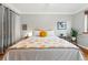 Spacious bedroom with natural lighting and a cozy yellow pillow at 1175 N Emerson St # 103, Denver, CO 80218