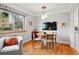Cozy dining area with hardwood floors, modern lighting, and a mounted TV at 1175 N Emerson St # 103, Denver, CO 80218