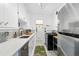 Well-maintained kitchen with white cabinets, quartz countertops, stainless steel appliances, and subway tile backsplash at 1175 N Emerson St # 103, Denver, CO 80218