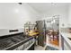 Bright kitchen with gas range, stainless steel refrigerator, and dining area view at 1175 N Emerson St # 103, Denver, CO 80218