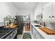Modern kitchen with white countertops, stainless steel sink, and adjacent dining area at 1175 N Emerson St # 103, Denver, CO 80218