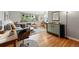 Sunlit living room with hardwood floors, large windows, and stylish furnishings creating a cozy and inviting atmosphere at 1175 N Emerson St # 103, Denver, CO 80218