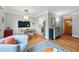 Charming living room with dining area featuring hardwood floors and ample natural light, offering a welcoming living space at 1175 N Emerson St # 103, Denver, CO 80218