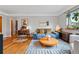 Bright living room with hardwood floors, comfortable seating, and a large window offering natural light and a pleasant view at 1175 N Emerson St # 103, Denver, CO 80218