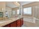 This large bathroom provides dual sinks, a soaking tub, and a glass enclosed shower at 6495 S Harvest St, Aurora, CO 80016