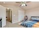 Bright bedroom with a walk-in closet, a modern chair, and neutral carpet at 6495 S Harvest St, Aurora, CO 80016
