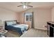 Cozy bedroom features a ceiling fan, a window with natural light, and neutral carpet at 6495 S Harvest St, Aurora, CO 80016