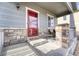 Covered porch with stone pillars and space for seating create a cozy outdoor space at 6495 S Harvest St, Aurora, CO 80016
