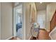 Well-lit entryway with hardwood floors, leading to a bedroom and staircase at 6495 S Harvest St, Aurora, CO 80016