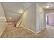 Upstairs hallway features neutral carpeting and access to bedrooms and stairwell at 6495 S Harvest St, Aurora, CO 80016