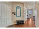 Inviting hallway with hardwood floors, a bench, and a decorative message board at 6495 S Harvest St, Aurora, CO 80016