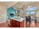 Open-concept kitchen and dining area, with a view of the home's inviting living area at 6495 S Harvest St, Aurora, CO 80016