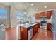 Bright kitchen boasts stainless appliances, granite countertops, and a large island at 6495 S Harvest St, Aurora, CO 80016