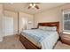 The main bedroom offers carpet, a large bed and a door leading to the on-suite bathroom at 6495 S Harvest St, Aurora, CO 80016