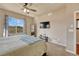 This main bedroom provides a window, carpet, a ceiling fan and a flat screen television at 6495 S Harvest St, Aurora, CO 80016