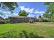 Spacious backyard featuring a well-maintained lawn, patio area, and mature landscaping at 8250 Chase Way, Arvada, CO 80003