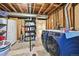 Unfinished basement with laundry area, showcasing utility connections and storage options at 8250 Chase Way, Arvada, CO 80003