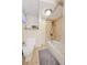 Cozy bathroom featuring a shower over tub, tile surround, and neutral color scheme at 8250 Chase Way, Arvada, CO 80003