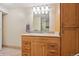 Bathroom vanity with wooden cabinets, granite countertop, modern fixtures, and neutral tiling at 8250 Chase Way, Arvada, CO 80003