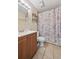 Bathroom with a wood vanity, tile floors, a toilet, and a shower with a curtain at 8250 Chase Way, Arvada, CO 80003