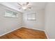 Bedroom with hardwood floors, two windows, and a ceiling fan at 8250 Chase Way, Arvada, CO 80003