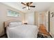 Bedroom featuring hardwood floors, a ceiling fan and a closet with a door to another room at 8250 Chase Way, Arvada, CO 80003