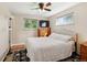 Bright bedroom with a ceiling fan, hardwood floors, and two windows at 8250 Chase Way, Arvada, CO 80003