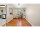 Cozy dining area with hardwood floors, a ceiling fan, and a view into the kitchen space at 8250 Chase Way, Arvada, CO 80003