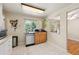 Bright and functional kitchen area with stainless steel appliances, tile flooring, and ample natural light at 8250 Chase Way, Arvada, CO 80003