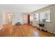 Open living area with hardwood floors, connecting to other rooms, with natural light from a large window at 8250 Chase Way, Arvada, CO 80003
