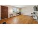 Bright living room featuring hardwood floors, a large window, and a welcoming front door at 8250 Chase Way, Arvada, CO 80003