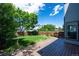 Relaxing backyard features a wooden deck, lush lawn, mature trees, and privacy fence at 5193 E 119Th Way, Thornton, CO 80233