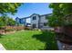 Spacious backyard with manicured lawn, wooden deck, and view of the home's exterior at 5193 E 119Th Way, Thornton, CO 80233