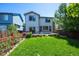 Lush backyard showcases a green lawn, wooden deck, and partial view of the home's exterior at 5193 E 119Th Way, Thornton, CO 80233