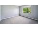 Neutral bedroom with carpeted floors and a large window allowing natural light at 5193 E 119Th Way, Thornton, CO 80233