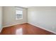 Empty bedroom with hardwood floors, natural light, and a window view at 5193 E 119Th Way, Thornton, CO 80233