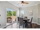 Bright dining area with sliding glass doors leading to an outdoor space and a modern ceiling fan at 5193 E 119Th Way, Thornton, CO 80233