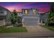 Charming two-story home with a well-manicured lawn and gray two-car garage, at sunset at 5193 E 119Th Way, Thornton, CO 80233